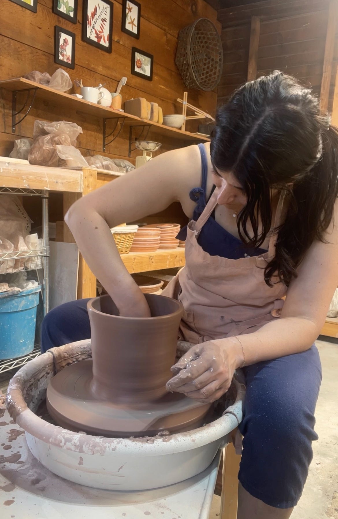 working on a vase on a pottery wheel
