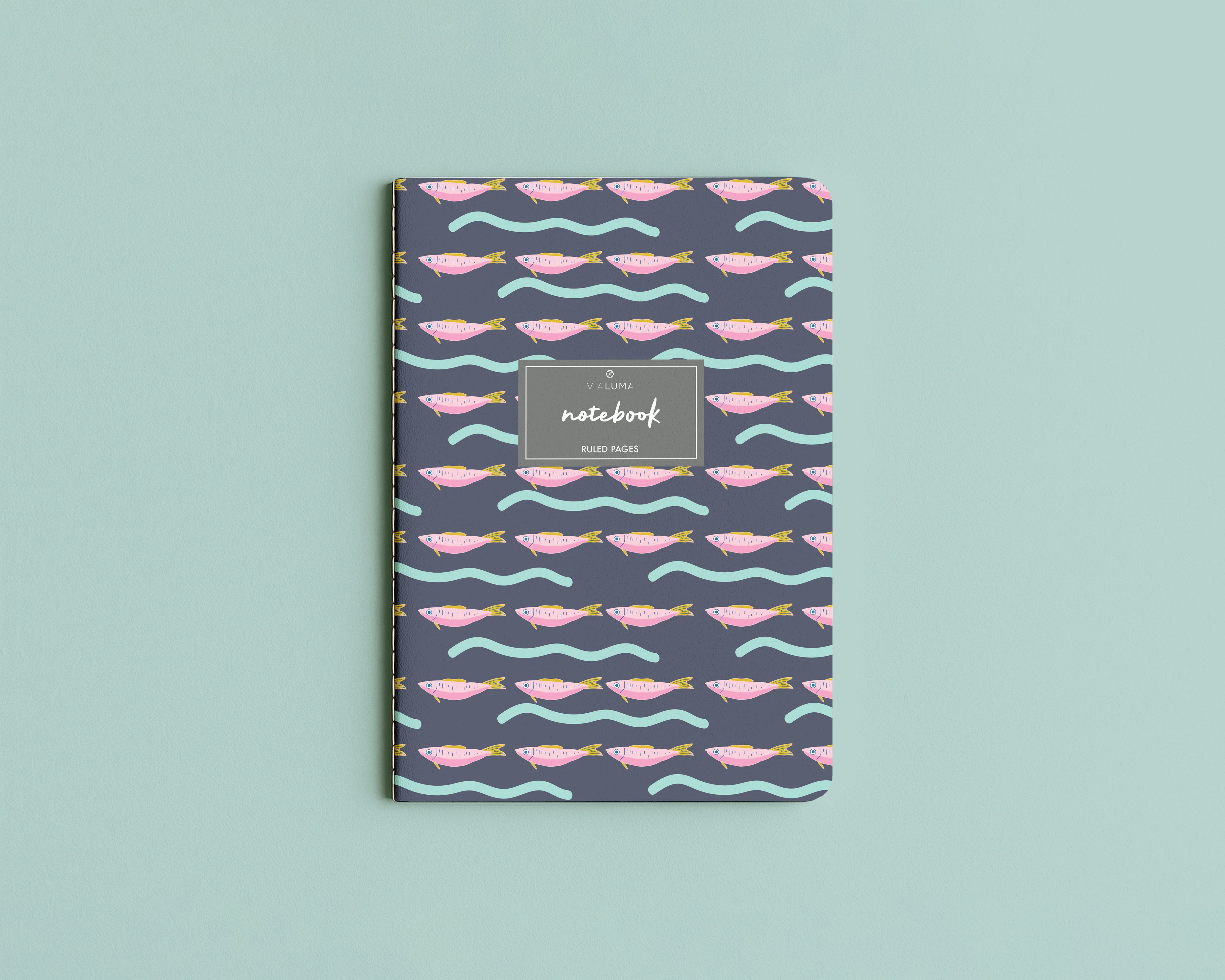 Notebook with fish pattern on a light blue background