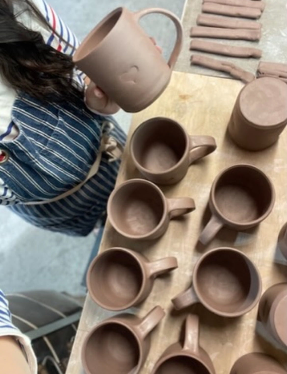 trimming pots for final steps and attaching mug handles