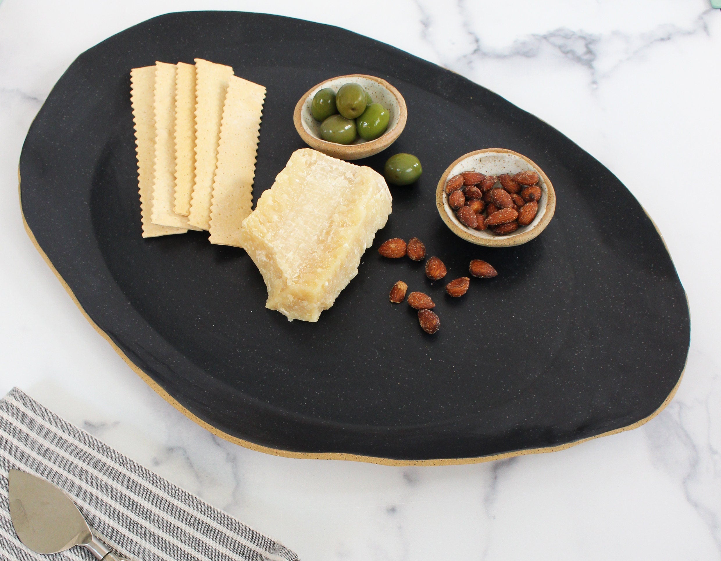 abstract black serving platter with charcuterie items