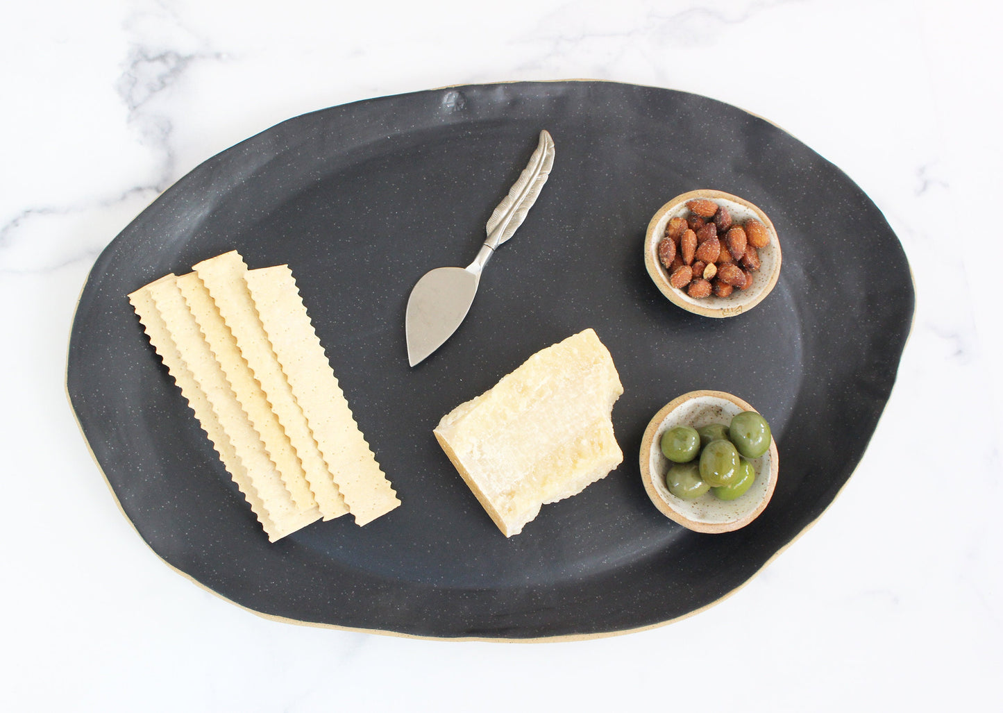 clay serving platter with cheese and crackers