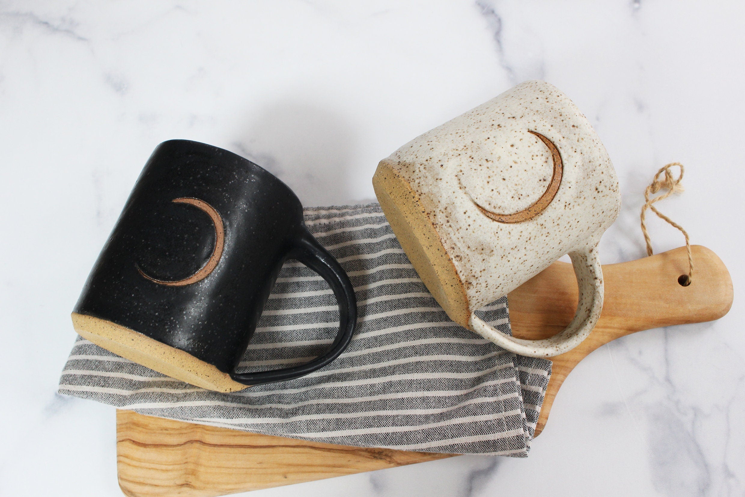 set of two speckled black and white moon mugs