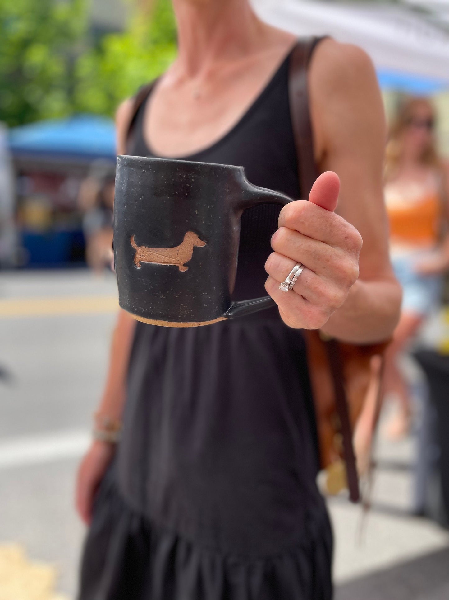 person at a central oregon market holding a dog mug